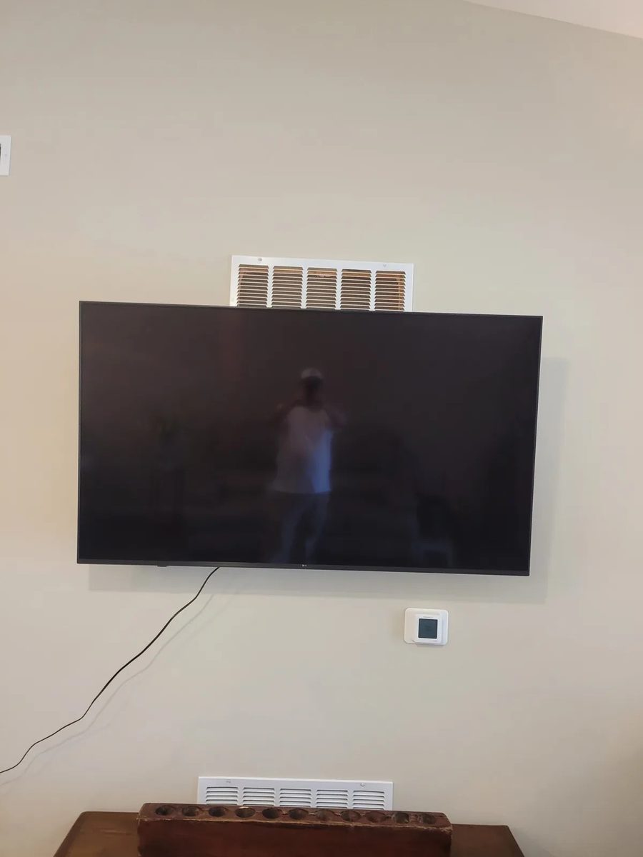 TV mount in progress on a living room wall in Greenwood, before the cords were dressed